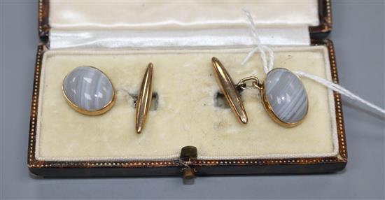 A pair of 9ct and cabochon grey banded agate set cufflinks, agate length 16mm, gross weight 7.7 grams.